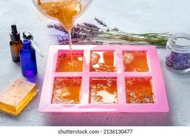 Handmade Soap, The Process Of Making. Liquid Glycerin With Lavender Buds And Essential Oils Pouring Into A Silicone Mold To Later Solidify Into Bars