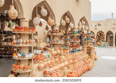 Handmade souvenirs and ceramic pottery jugs trade market in bazaar of Nizwa, Sultanate Oman - Powered by Shutterstock