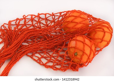 Handmade string bag with three oranges