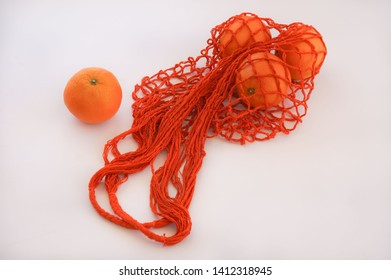Handmade string bag with three oranges