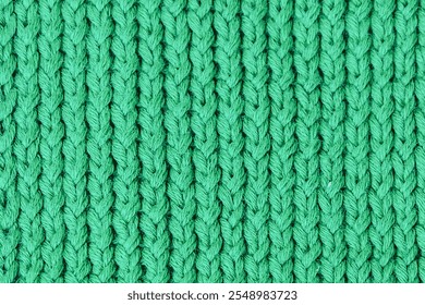 Handmade texture of knitted pattern made with green wool yarn