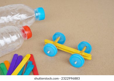 Handmade toy racing car made from ice cream sticks and bottle caps. Concept, Recycling kids toy. Easy to do, creative DIY craft that kids can do. Recycle invention.                              