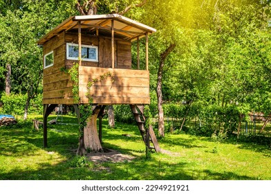 Handmade tree house in sunny green garden - Powered by Shutterstock