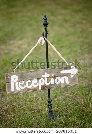 Handmade wedding sign pointing towards reception 