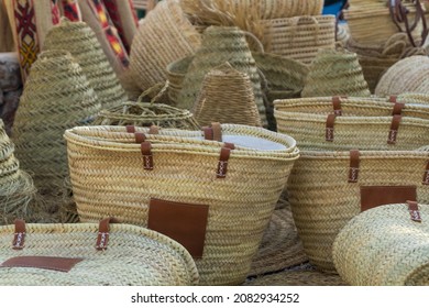 Handmade wicker or esparto grass bag. Raffia bag or basket at a hippie market. Street sale of women's handbags.