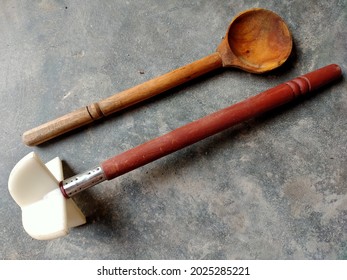 Handmade wooden spoon and traditional wooden butter churner isolated on ground background. Old Wooden hand mixer and wooden spoon on ground background. - Shutterstock ID 2025285221