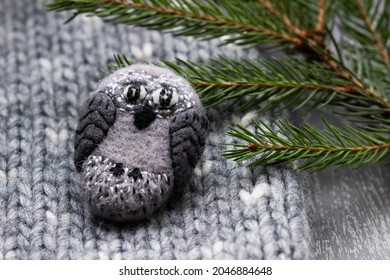 Handmade wool brooch on a sweater background. Selective focus.