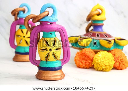 Hand-painted Decorative clay lamps for the festival of lights Diwali. Indian Traditional clay hanging lamps. Happy Diwali banner. Copy space.