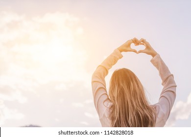 The hand-painted girl's silhouette is a heart-shaped symbol of love, compassion, and friendship with beautiful tranquility on a sunny background in the morning of winter in Thailand.
Love concept