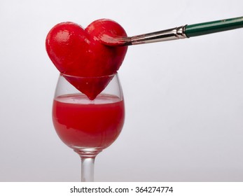 Hand-painted red heart on glass, on a white background