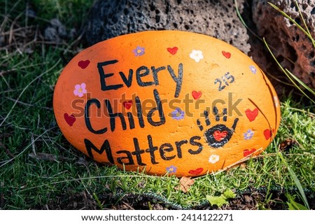 A handpainted rock that says 