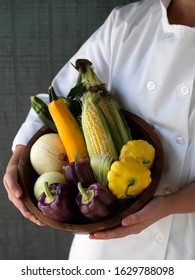 handpicked farm and garden vegetables with chef in chef coat and farmer with basket