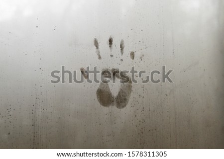 Handprint Impression on Steamy Glass Window