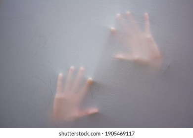 Handprint of woman as she suffocates behind fabric, raised hands. Mystery concept. Shadow blur of screaming woman. Touching the void. Close up photo. 