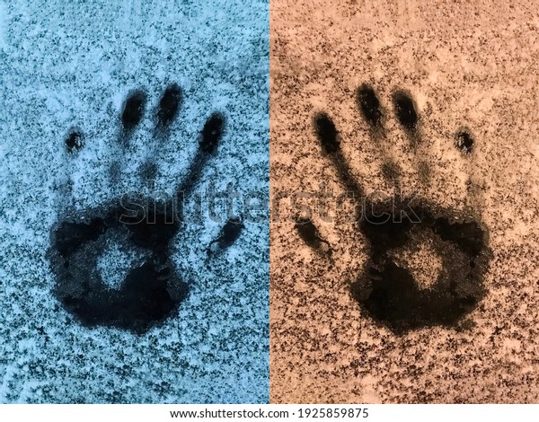 Handprints on the snowy ice. Blue and yellow\
abstract background with palm\
footprints