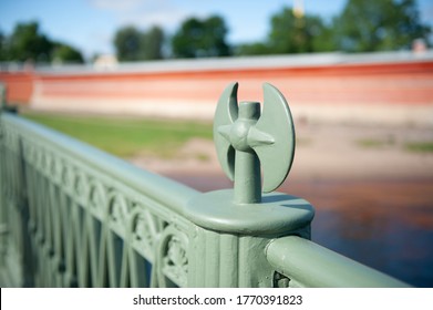 Handrail of the bridge with a decorative element in the form of an ax