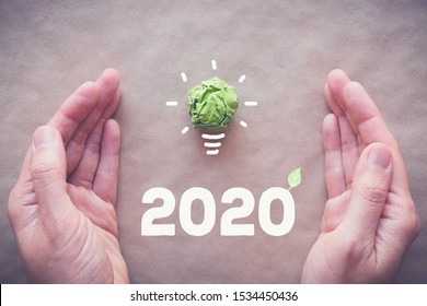 Hands With 2020 Green Paper Light Bulb, New Year Eco, Social Responsibility, Csr, Innovation Solution Concept, Climate Change Global Action