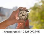 hands adjusting or changing the time on clock