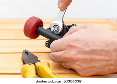 Hands Adjusting Nuts With Wrench And Tools On Table