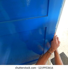 Hands Affixing Adhesive Rubber Draft Proofing To A Door Frame.