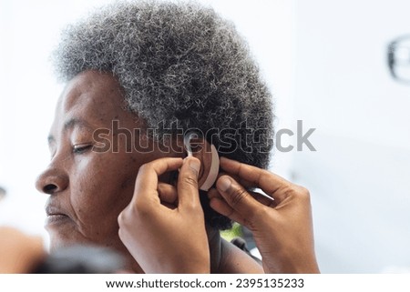 Similar – Image, Stock Photo Woman applying hearing aid to ear