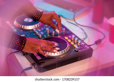 Hands Of African Female Deejay Moving Turntable While Standing By Desk And Mixing Sounds And Making New Music For Disco Dancing