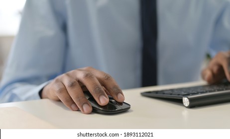 Hands of African Man Using Mouse and Keyboard, Close Up 