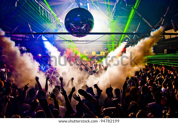 Hands In Air Rave With Smoke Machine and Laser\
Crowd - Nightclub