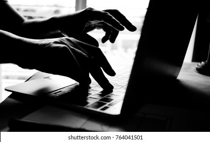 hands of anonymous hackers typing code on keyboard of laptop for remotely reach and receiving personal information online networking, Internet Crime Payment Security Concept, Silhouette black white - Powered by Shutterstock - Get 15% off with code: PIKWIZARD15
