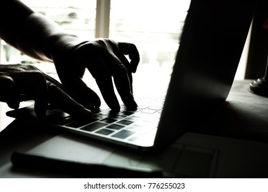 hands of anonymous hackers typing code on keyboard of laptop for remotely reach and receiving personal information online networking, Internet Crime Payment Security Concept, Silhouette black white - Powered by Shutterstock - Get 15% off with code: PIKWIZARD15