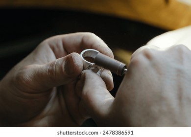 Hands of an artisan jeweler working jewelry. Jewelry Goldsmith - Powered by Shutterstock