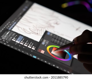 The hands of an artist selecting color on a digital drawing tablet. Caserta, Italy, July 07th 2021.