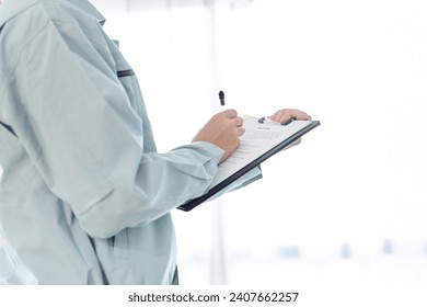 Hands of an Asian worker doing inspection - Powered by Shutterstock