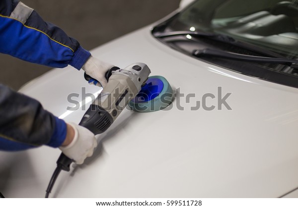 Hands with Auto\
polisher. Car repair\
service.