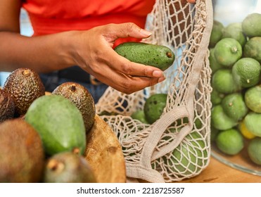 Hands, Avocado And Bag With A Woman Customer Shopping In A Grocery Store For A Health Diet Or Nutrition. Supermarket, Food And Retail With A Female Shopper In A Shop Produce Aisle For Groceries