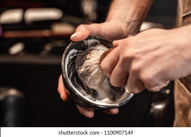 hands of barber with brush for shaving beard and bowl. barber shop - Powered by Shutterstock