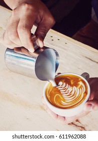 Hands Of Barista Making A Cup Of Coffee Latte Art.