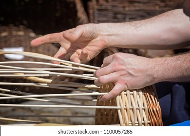 Hands Of A Basket Maker Are Braiding A Wicker Basket, Selected Focus