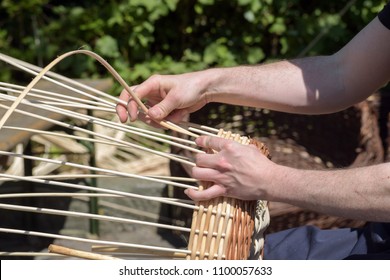 Hands Of A Basket Maker Weave A Wicker Basket