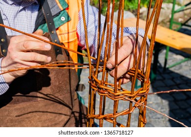 Hands Of A Basket Maker Weaving A Wicker Basket