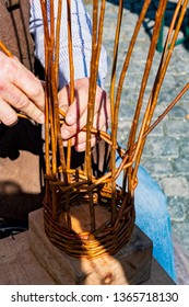 Hands Of A Basket Maker Weaving A Wicker Basket