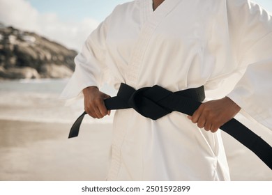 Hands, beach and man with black belt, karate and fitness with pride for achievement, goal and nature. Fighter, workout and sensei with vacation, seaside and martial arts with training and practice - Powered by Shutterstock