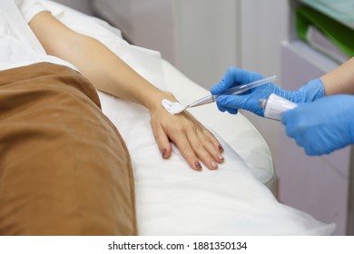 The Hands Of A Beautician Doctor Apply Anesthetic Cream To The Patient's Hands