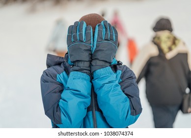 Hands before face
