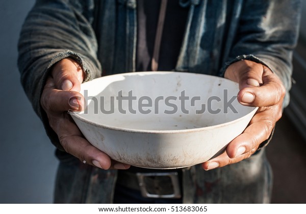 hands of beggar with\
bowl begging for rice