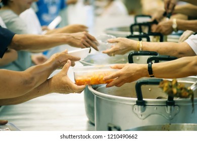 The hands of beggars get food from the donor : The life of the poor - Shutterstock ID 1210490662