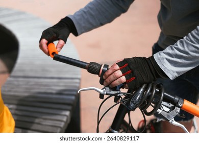 Hands of a bicycle mechanic installing new handlebar grips, replacing worn-out ones. Bike repair, diagnostics, and adjustment of cycling components. Manual maintenance of eco transport - Powered by Shutterstock - Get 15% off with code: PIKWIZARD15