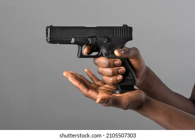 Hands Of A Black Man Closing A Magazine Loaded With Ammunition On A Pistol In The Aim Position In A Concept Of Crime, Violence, Law Enforcement Or Self Defence