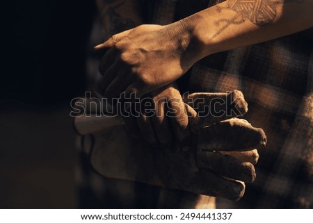 Hands, blacksmith or gloves in workshop for protection, forging or safety. Person, production or preparation in metal industry for labor, project or artisanal creativity in foundry for small business