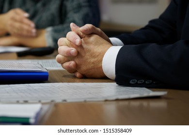 Hands Of The Boss During A Meeting And Adjudication. Clenched Fingers. Teamwork. Shallow Depth Of Field.